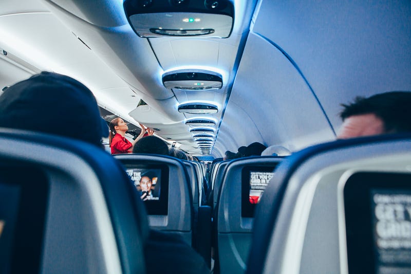 Flight attendant serving passengers on a 747