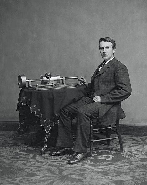 Edison with his phonograph, showcasing his inventions