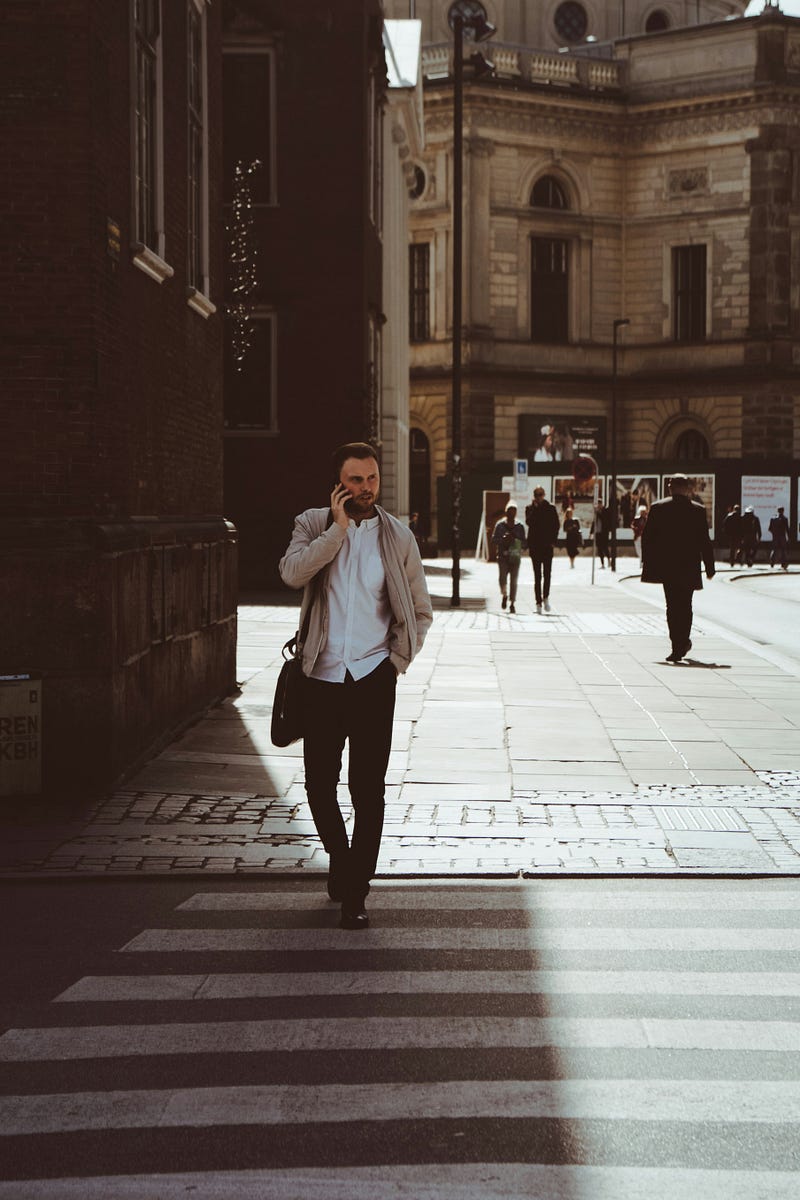 Young woman distracted by her phone while walking