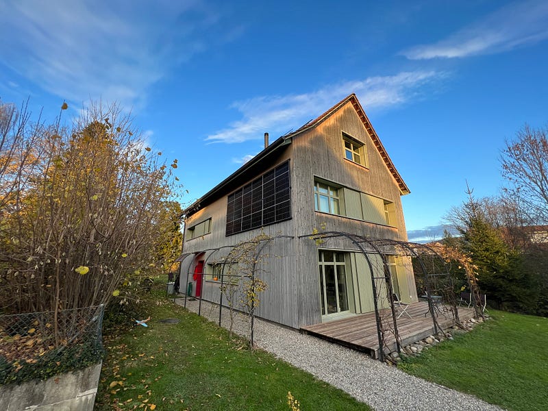 Vertical solar panels on the western facade of a home